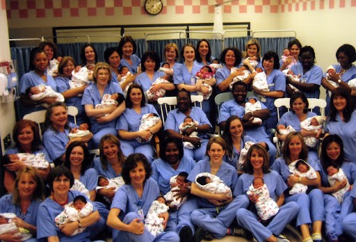 Midwives posing with babies