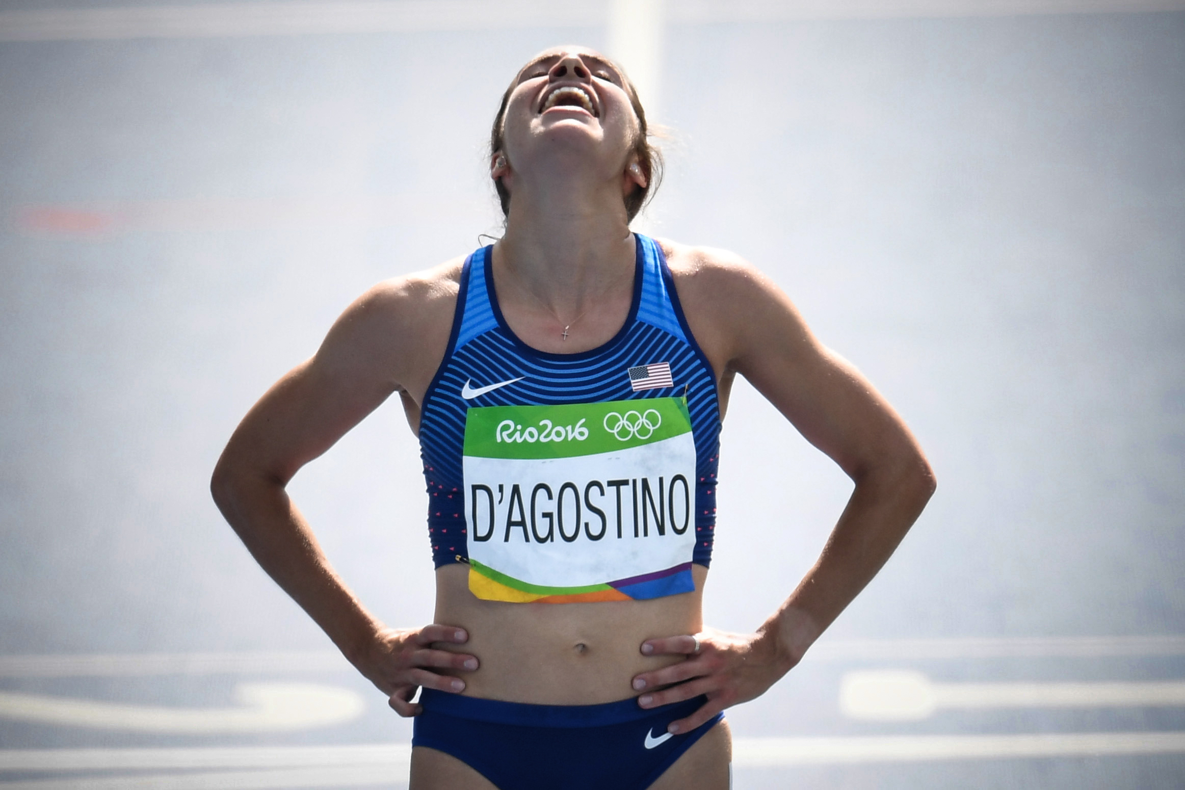 USA's Abbey D'agostino reacts after competing in the Women's 5000m Round 1 during the athletics event at the Rio 2016 Olympic Games at the Olympic Stadium in Rio de Janeiro on August 16, 2016.   / AFP PHOTO / PEDRO UGARTE