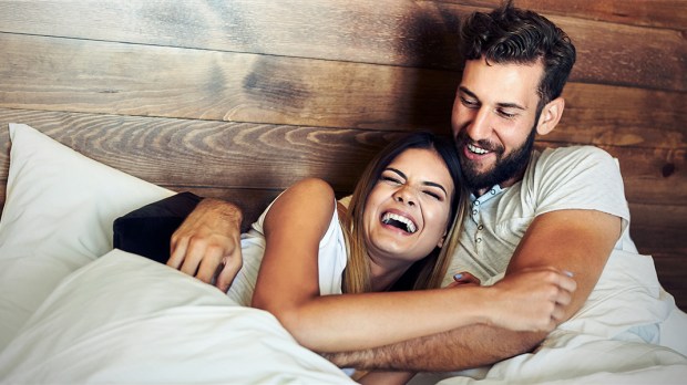 WEB3-LAUGHING-LAUGH-HUSBAND-WIFE-BED-LOVE-SMILES-Shutterstock