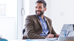 MAN WORKING AT DESK