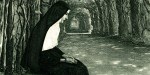 NUN SITTING ON BENCH,FOREST