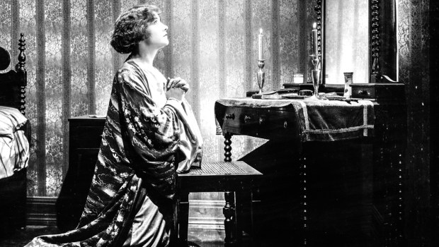 WOMAN PLEADING IN FRONT OF MIRROR