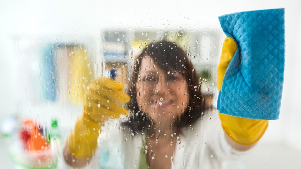 WOMAN CLEANING GLASS