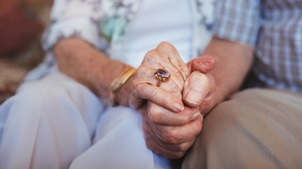 OLD COUPLE HAND IN HAND