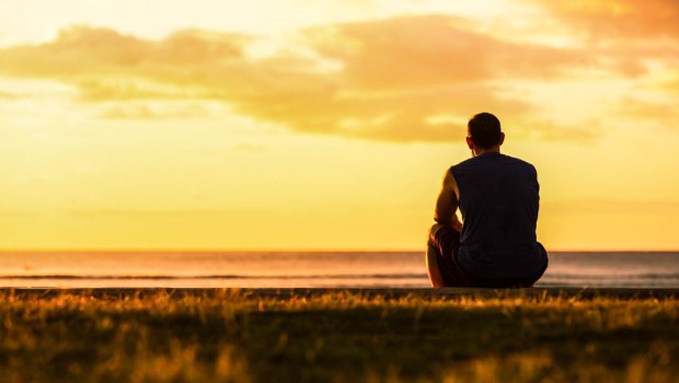 MAN SITTING ALONE