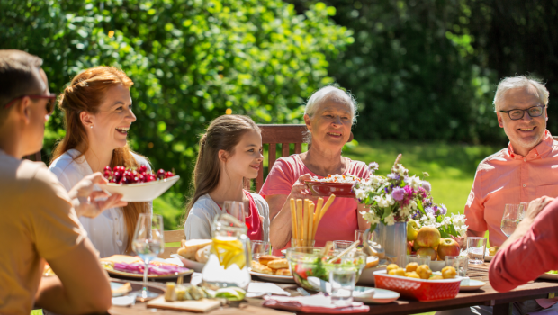 happy family having festive dinner or summer garden party