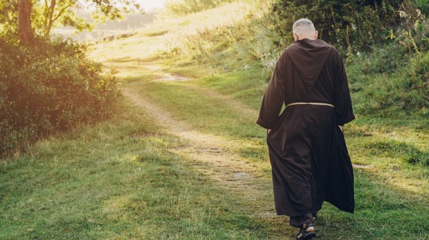 monk walking green path