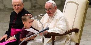 Little boy joins Pope Francis on stage, as he calls for closeness of elderly and youth