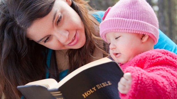 Godmother and baby with bible