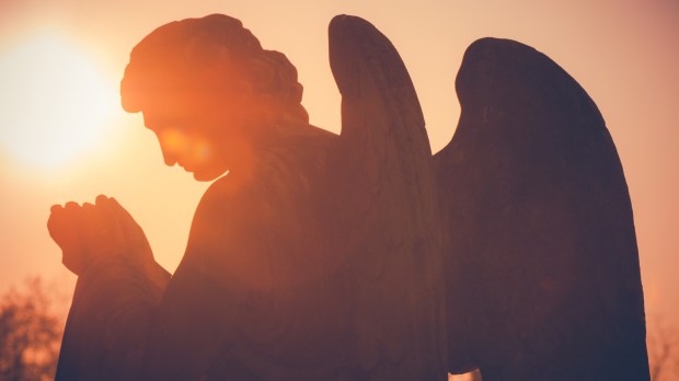 guardian angel sculpture at sunset