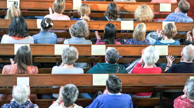 Catholics sitting in full pews at in-person Mass