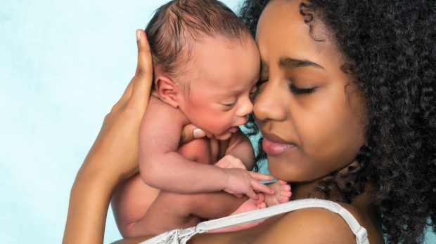 Mother cradling newborn