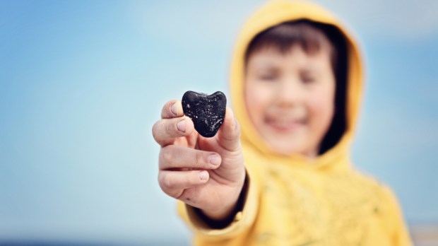 child holding a stone
