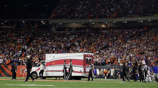 Fans look on as the ambulance leaves carrying Damar Hamlin #3 of the Buffalo Bills