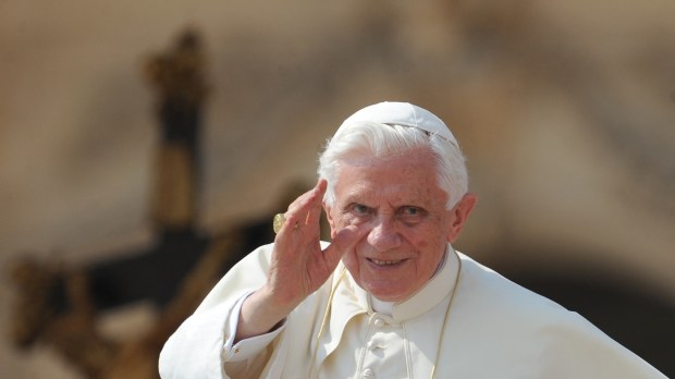 Pope Benedict XVI waves as he arrives for his weekly general audience