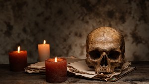 skull on table with candles