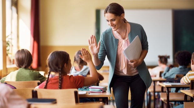 Good teacher high five student classroom