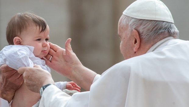 Pope Francis blesses a child