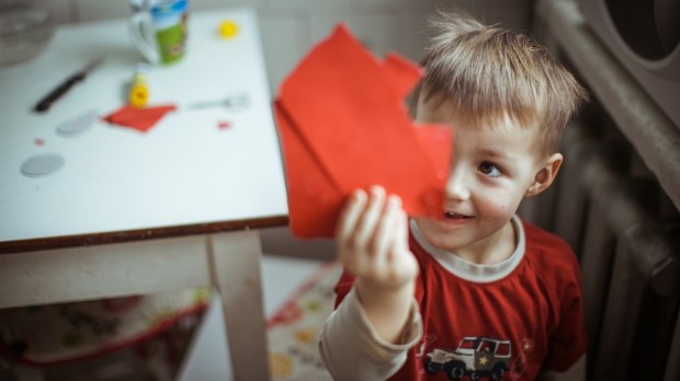 Child with cut-up paper