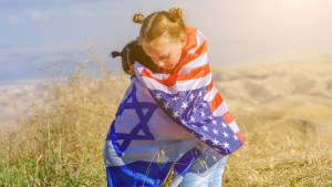 Girls hugging with Israeli and American flags