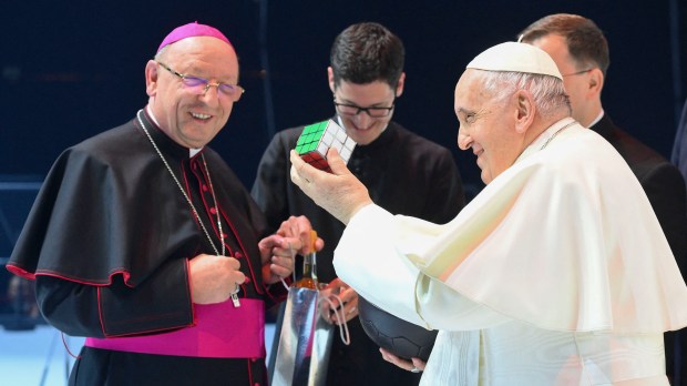 Pope Francis holds up a rubik's cube he received during a meeting with young people at Papp Laszlo Sportarena during his visit in Budapest Hungary