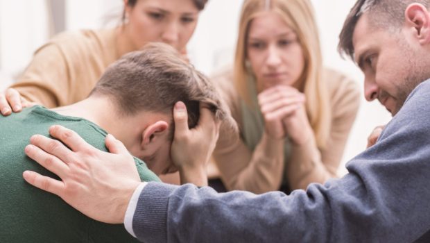sad-young-man-group-therapy-friends-addiction
