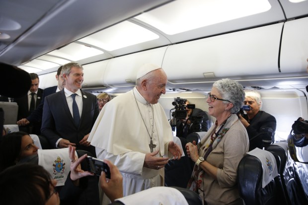 Portuguese journalist Aura Miguel greets Pope Francis on a papal flight