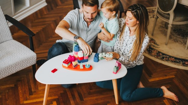 Mom and dad playing game with young child