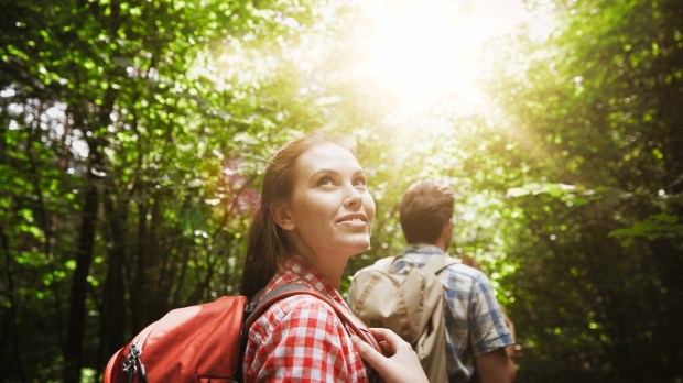 Woman hiking with friends in forest