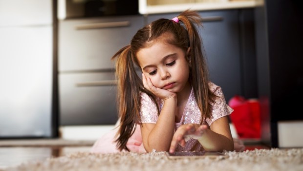 bored little girl on carpet
