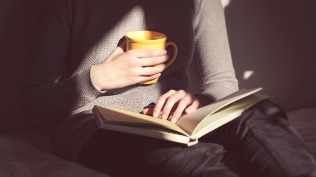 woman hands coffee reading dark