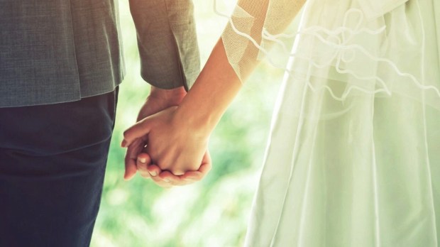 Bride and groom holding hands