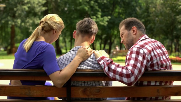 Parents speaking to a teenaged son