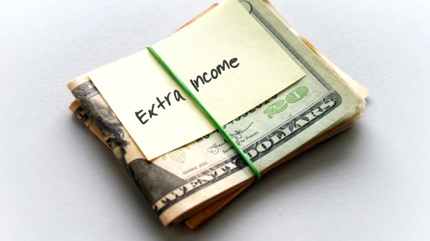 wad of cash with "extra income" note