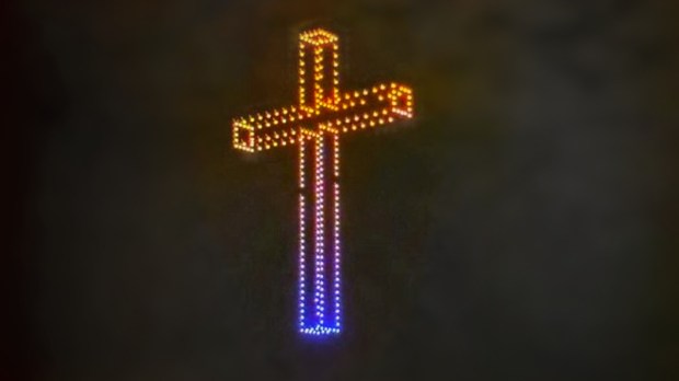 A cross formed by drones with lights in the sky above Budapest