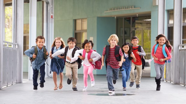 Children running through school hall