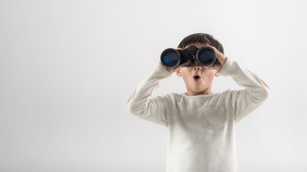 boy binoculars surprised