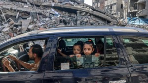 Family drives through rubble of Gaza Strip