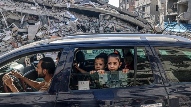 Family drives through rubble of Gaza Strip