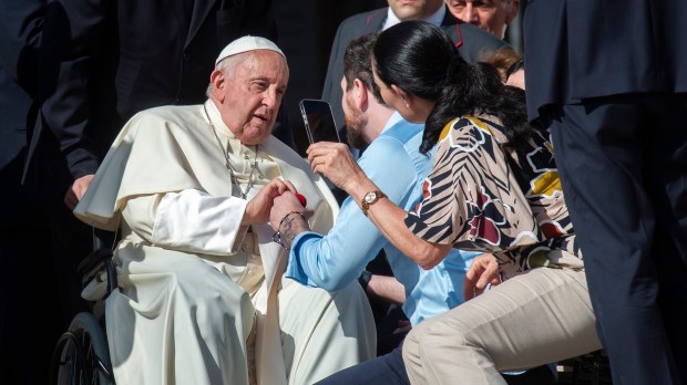 Pope Francis blesses a couple at the conclusion of his weekly general audience.