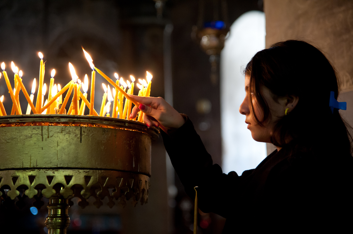 Palestinian youth lights candle in church in 2012