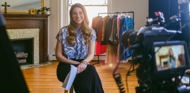 Author Lillian Fallon with clothes rack in the background