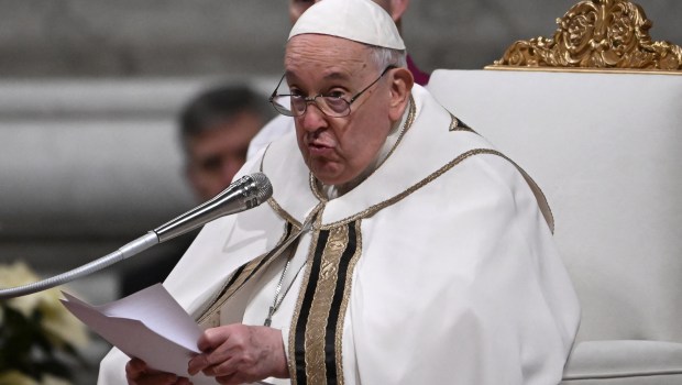 A picture shows a figurine of the baby Jesus during the Christmas Eve mass at St. Peter's Basilica in the Vatican on December 24 2023