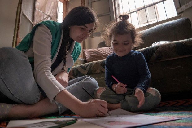 A little girl in Aleppo, Syria receives much needed attention from AVSI
