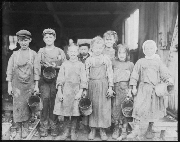 Young oyster shuckers in city