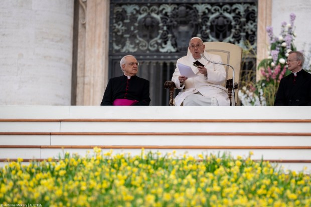 Pope Francis holds a small new Testament from a 23 year old soldier which died in Ukraine