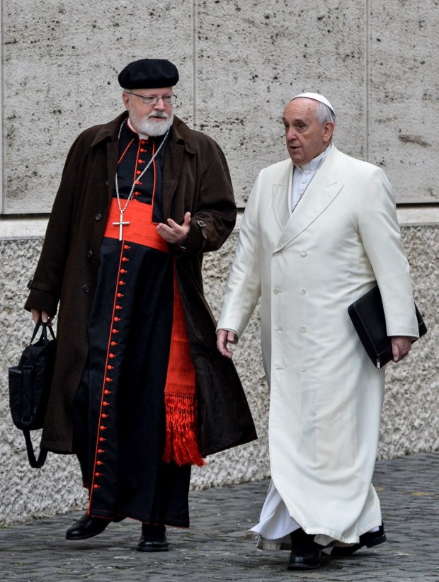 Pope Francis (R) speaks with US Cardinal Sean Patrick O'Malley as he arrives to take part with cardinals and bishops in the Papal consistory before the nominations of new cardinals, at the Vatican on February 13, 2015.