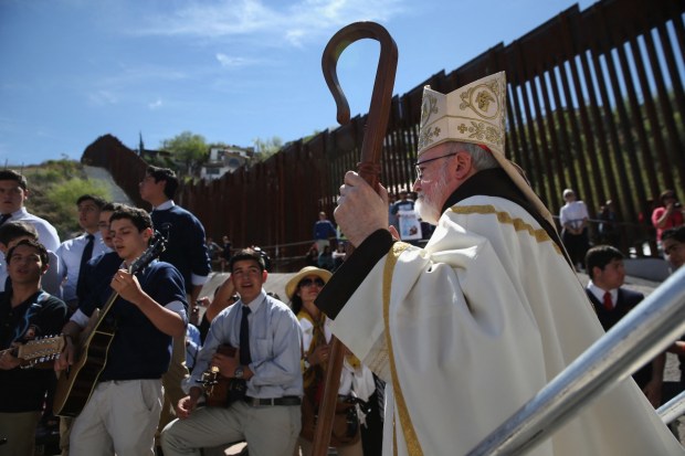 Archbishop of Boston Cardinal Sean O'Malley walks near the U.S.-Mexico border fence following a special 'Mass on the Border' on April 1, 2014 in Nogales, Arizona.