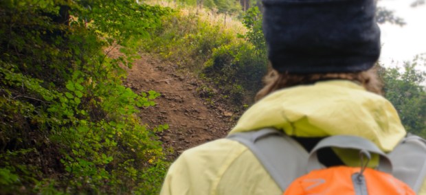 Close up man on trail looking at hard path
