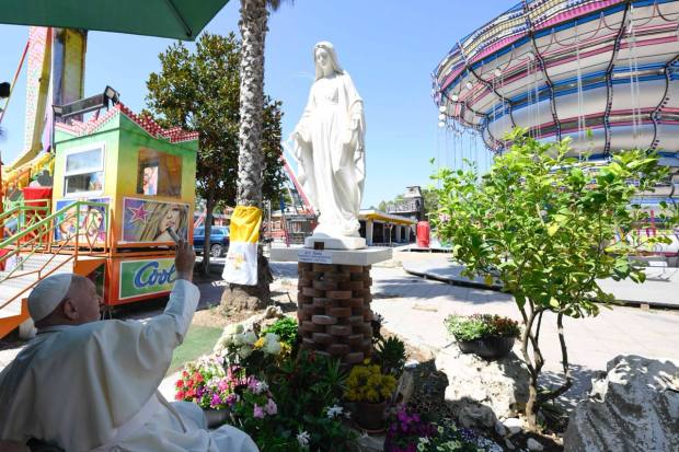 Pope Francis blessing the statue of Our Lady, Patroness of the Traveling Show and Circus, at the Ostia amusement park on July 31, 2024.